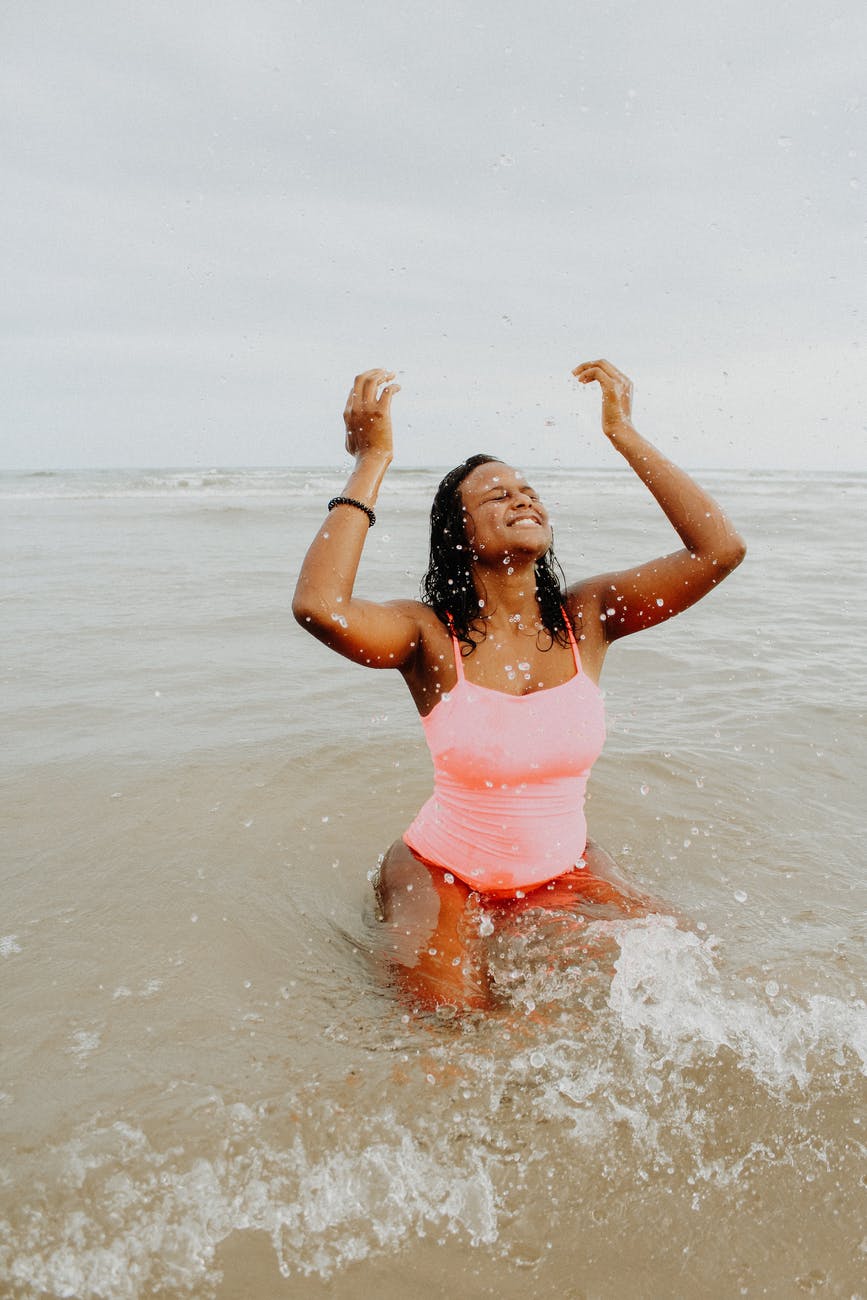 woman playing in the ocean