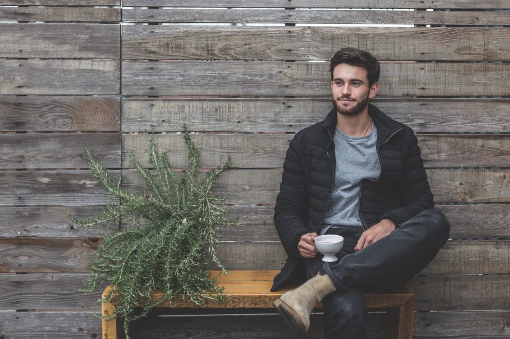 guy sitting on bench outside