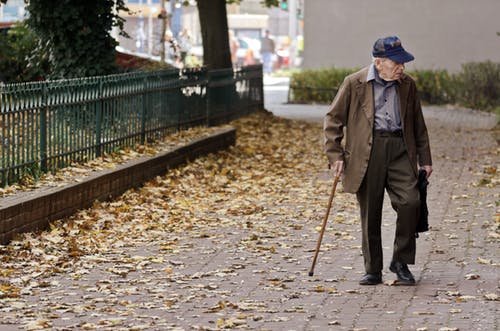 an elderly man with a cane