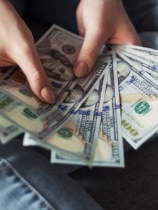 woman holding 100 dollar bills